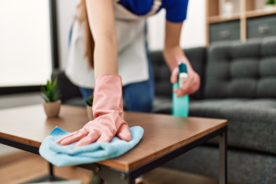 Cleaning lady cleaning a table